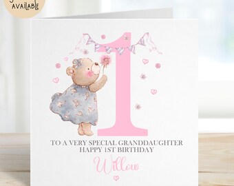May include: A birthday card featuring a pink number 1 and a teddy bear holding a flower. The card reads "To a very special granddaughter Happy 1st Birthday Willow". The words "Matching giftwrap AVAILABLE" are in a circle in the upper left corner.