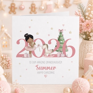 Personalised 2026 Christmas card for a great granddaughter, featuring a cute black haired ballerina holding a bunny beside a pink Christmas tree, rocking horse and presents, with gold stars, pink hearts and the name Elsie.