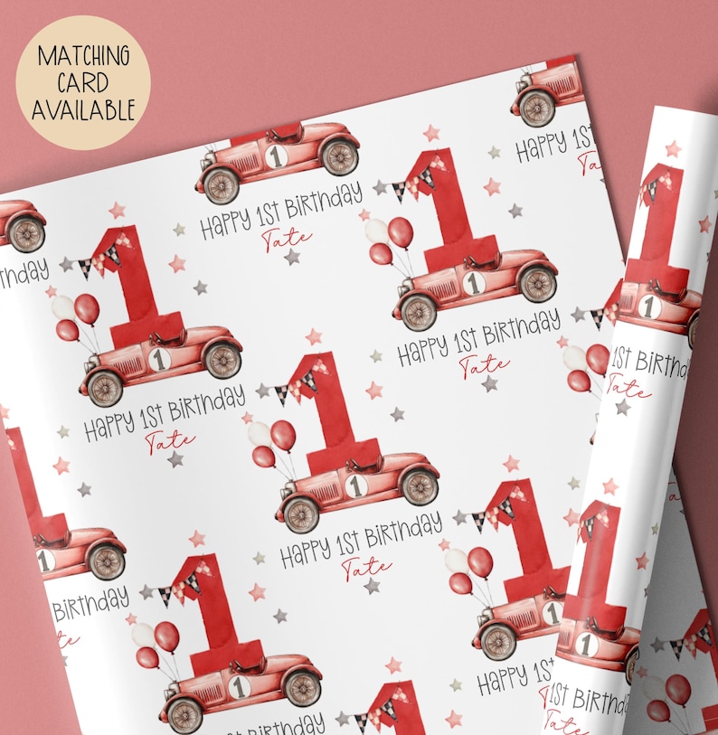 Luxury white personalized 1st birthday race car themed wrapping paper, featuring a watercolor red racing car with the number 1 on the side of it & a large number 1 with bunting & balloons and the wording 'Happy 1st Birthday' personalised with the child's name.