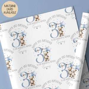 Luxury white personalised 3rd birthday wrapping paper, featuring a gorgeous teddy holding a blue star balloon standing next to a blue number 3 & matching bunting surrounded by little stars & the wording 'Happy 3rd Birthday to our wonderful Son/Grandson/Nephew, any relation' personalised with the child's name.