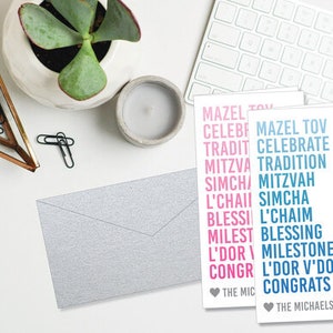 May include: Two cards with a blue and pink gradient design. The cards feature a list of Hebrew words and their English translations. The words include "Mazel Tov", "Celebrate", "Tradition", "Mitzvah", "Simcha", "L'Chaim", "Blessing", "Milestone", "L'Dor V'Dor", and "Congrats". The cards are signed "The Michaelsons" and "The Mic".