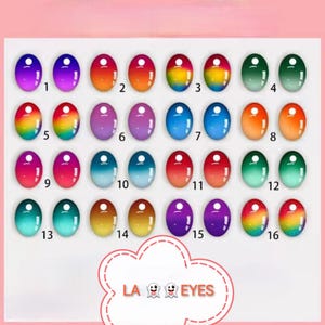 Puede incluir: Una colección de dieciséis diseños de ojos ovalados y coloridos, cada uno con un pequeño agujero en la parte superior. Los colores varían de azules y verdes a naranjas y morados, algunos con gradientes de arcoíris. El texto "LA EYES" está en la parte inferior.