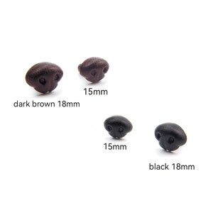 May include: A collection of four plastic doll noses in dark brown and black. Two are dark brown, one is 18mm and the other is 15mm. The other two are black, one is 18mm and the other is 15mm.