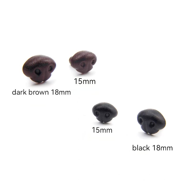 May include: A collection of four plastic doll noses in dark brown and black. Two are dark brown, one is 18mm and the other is 15mm. The other two are black, one is 18mm and the other is 15mm.
