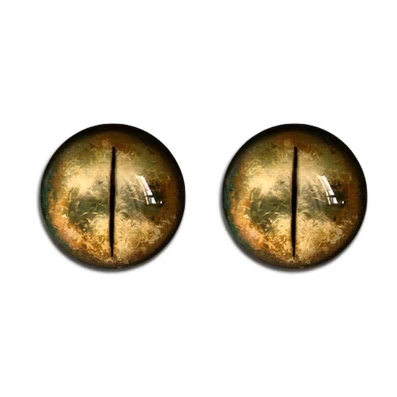 K&ouml;nnte beinhalten: Ein Paar realistisch aussehende Glasaugen in Gelb- und Braunt&ouml;nen. Die Augen haben eine vertikale schwarze Pupille.