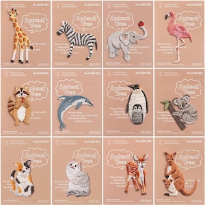 May include: A selection of embroidered animal patches, featuring a giraffe, zebra, elephant, flamingo, raccoon, dolphin, penguin, koala, cat, deer, and kangaroo. Each patch has the text "Animal Tree". The patches are displayed on a light brown background.