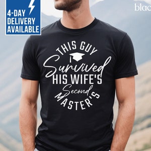 May include: Black t-shirt with white text that reads "This Guy Survived His Wife's Second Master's". The text is in a circle with a graduation cap icon above the word "Survived".