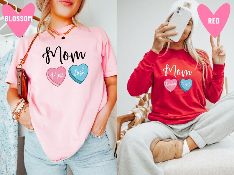 May include: Two pink and red t-shirts with the word "Mom" and two candy hearts with names on them. The pink shirt has the names "Mac" and "Josh" on the hearts. The red shirt has the names "Emma" and "Fred" on the hearts.