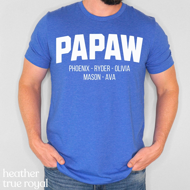 May include: A royal blue t-shirt with the word "PapaW" in white text. Below the word "PapaW" is the text "Phoenix - Ryder - Olivia Mason - Ava" in white text.