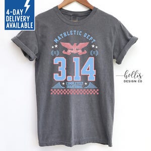 May include: A gray t-shirt with a graphic design that says "Mathletic Dept" with a stylized eagle and the number "3.14" in blue. The text below the number says "Completely Irrational".
