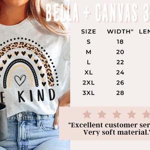 May include: A white t-shirt with a rainbow design featuring a leopard print and the text "BE KIND". The shirt is available in sizes S-3XL. The size chart shows the width and length of the shirt in inches.