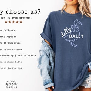 May include: A navy blue t-shirt featuring the words "dilly dally" and a white duck illustration. The shirt is part of a clothing range. The image also includes text that says "why choose us?" and lists the company's benefits.