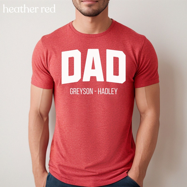 May include: Heather red t-shirt with white text that reads "DAD GREYSON - HADLEY"