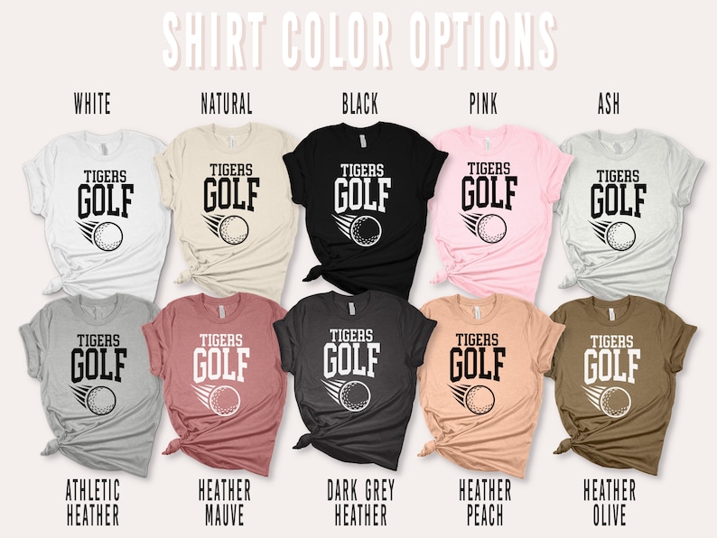 May include: A set of ten t-shirts in various colours, each featuring a graphic of a golf ball with the text "TIGERS GOLF". The colours include white, natural, black, pink, ash, athletic heather, heather mauve, dark grey heather, heather peach, and heather olive.