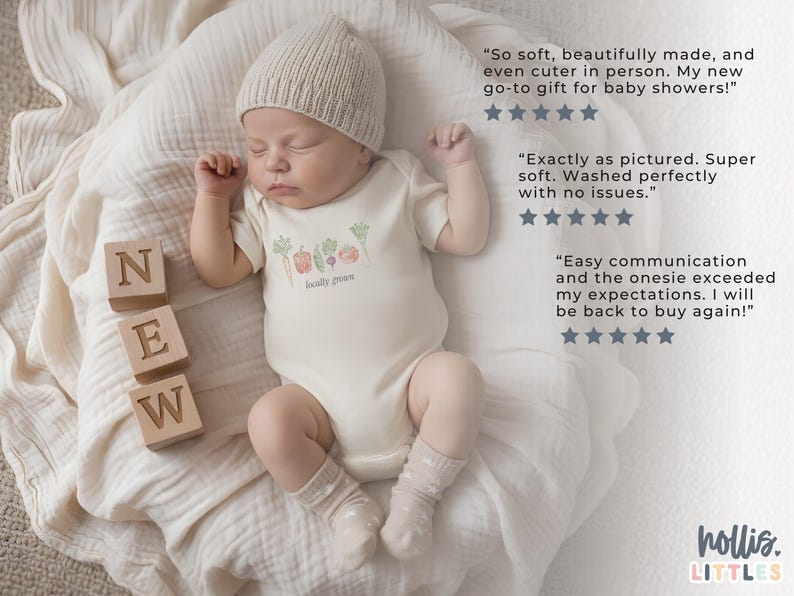 May include: A newborn baby wearing a beige knit cap and a cream-colored onesie with a "locally grown" vegetable design. Wooden blocks spell "NEW" next to the baby. The baby is lying on a soft, cream-colored blanket.