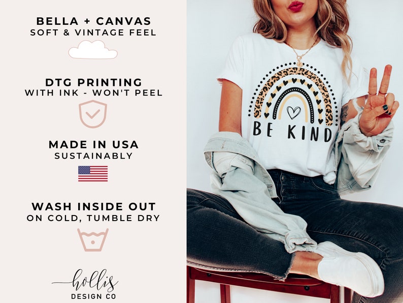 May include: White t-shirt with a rainbow graphic featuring a leopard print and black hearts. The rainbow has a small heart in the center and the text "BE KIND" below it.