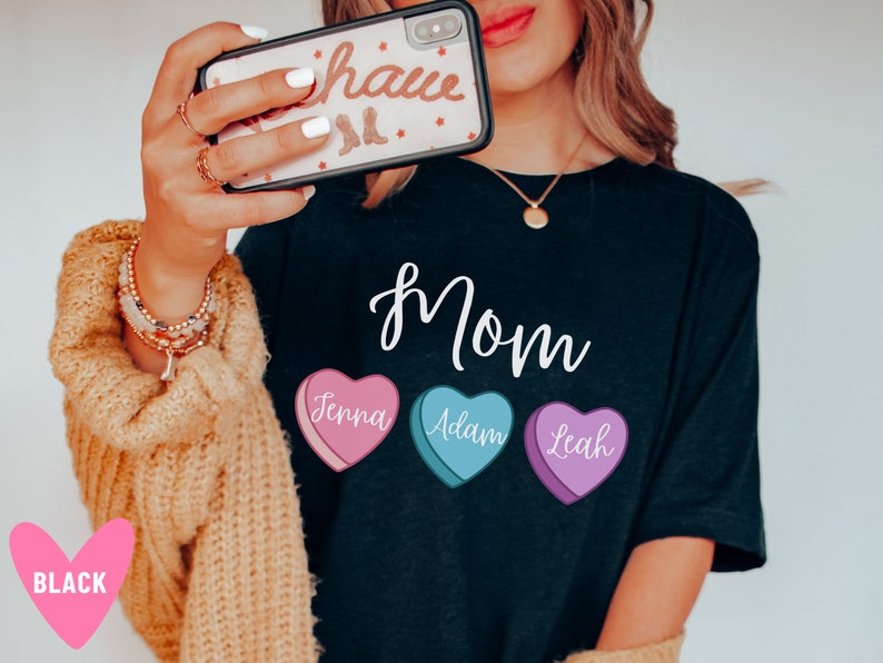 May include: Black t-shirt with the word "Mom" and three candy hearts with the names "Jenna", "Adam", and "Leah" printed on them.