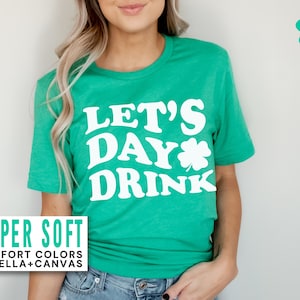 May include: A green t-shirt with the text "Let's Day Drink" in white with a shamrock graphic. The shirt is super soft and made of comfort colors or Bella + Canvas.