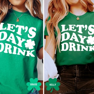 May include: Two green t-shirts with white text that reads "Let's Day Drink" and a shamrock graphic.
