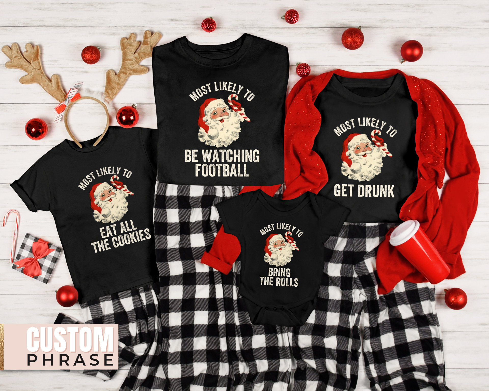 May include: Four black t-shirts with a Christmas theme. Each shirt features a cartoon image of Santa Claus with a candy cane and text that says "Most Likely To" followed by a funny Christmas-themed phrase. The phrases are "Eat All The Cookies", "Be Watching Football", "Bring The Rolls", and "Get Drunk".