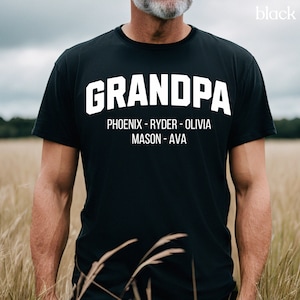 May include: Black t-shirt with white text that reads "GRANDPA" and "PHOENIX - RYDER - OLIVIA MASON - AVA"