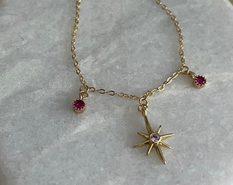 Fine gold bracelet with round tassels and fuchsia pink zircon star