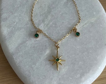 Fine gold bracelet with round tassels and green zircon star