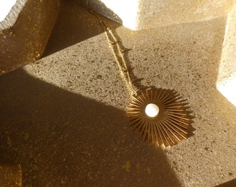 Golden steel sun necklace and mother-of-pearl cabochon