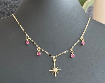 Fine gold necklace with round tassels and fuchsia pink zircon star