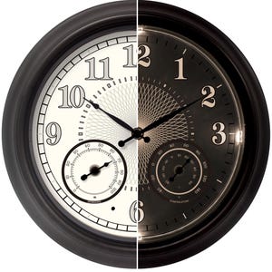 May include: A two-tone wall clock with a black frame. The left side features a white face with black numerals and a humidity gauge. The right side has a black face with beige numerals and a temperature gauge. The clock hands are black.