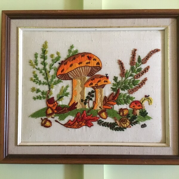 Beautiful vintage framed crewel art featuring mushrooms,ladybugs,acorns.