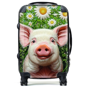 May include: A black suitcase with a whimsical design featuring a pink pig with a white snout and a green floral background. The pig is surrounded by white daisies.
