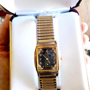 May include: A set of three ceramic mugs with a speckled, matte finish. The mugs are in shades of cream, light gray, and dark gray. Each mug has a simple, minimalist design and a rounded handle.