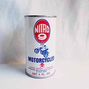Puede incluir: Una lata blanca con una etiqueta roja y azul. La etiqueta dice "NITRD 9" en un c&iacute;rculo rojo con un n&uacute;mero 9 blanco. La etiqueta tambi&eacute;n dice "FOR MOTORCYCLES" en letras azules. La lata tiene un s&iacute;mbolo de calavera y huesos cruzados y el texto "DANGER: POISON - FLAMMABLE" en la etiqueta. La lata dice "NET 4 FL. OZ."