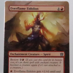 May include: A fantasy creature card with a fiery red and orange background. The card features a creature with antlers and glowing eyes. The card text reads "Everflame Eidolon" and has a power and toughness of 1/1.