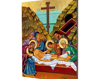 May include: A religious icon depicting the Entombment of Christ. The icon features a group of people surrounding the body of Jesus, who is lying on a white cloth in a tomb. The icon is painted in a traditional style with vibrant colors and gold accents.