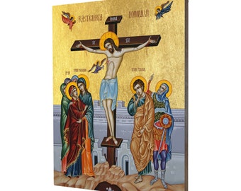 May include: A religious icon depicting Jesus Christ on the cross with a gold background. The icon features a detailed depiction of Jesus with a crown of thorns and a blue robe. There are figures of women and men surrounding the cross, including Mary, John the Apostle, and a Roman soldier. The icon is painted in a traditional Byzantine style.