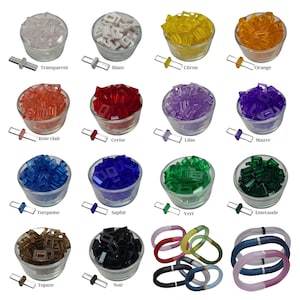 May include: Assortment of colorful glass tiles in various colors, including transparent, white, citron, orange, rose, cherry, lilac, mauve, turquoise, sapphire, green, emerald, topaz, and black. The tiles are arranged in small bowls and are ready to be used for crafting projects.
