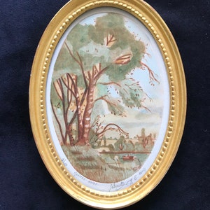 May include: A framed watercolor painting of a landscape with trees and a river. The painting is signed "Jacqueline F. 6. 2004" and "Hantiere-Noire".