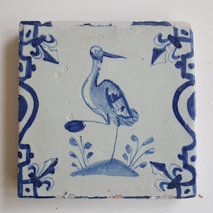 Antique Dutch Tile with a crane with stone in its foot decorated with baluster sides and french lily corner motifs - Dated 1640, Dutch Delft