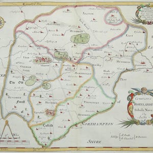 May include: An antique map with detailed cartography, featuring colored borders and place names. The map includes a compass rose, a scale of miles, and decorative cartouches. A historical document.