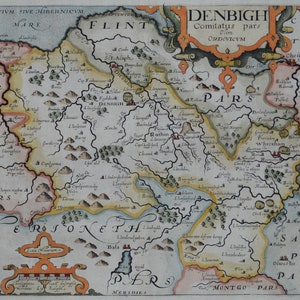 May include: A detailed, antique map of Denbighshire, Wales, with surrounding areas. The map features intricate details, including towns, rivers, and geographical features, with text labels in Latin. The map is colored with shades of yellow, green, and brown.