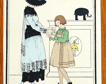 May include: A woman in a black and white dress with a black hat gives a gift to a girl in a green and brown dress. The girl is standing in front of a fireplace with a black silhouette of an elephant above it.