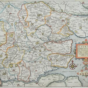 May include: An antique map of Essex, England, with a compass rose and a decorative border. The map shows the county's towns, rivers, and other geographical features. The title "ESSEXIA COMITATVS.QVEM TRINZHANY" is printed in a decorative banner.