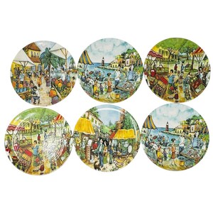 May include: A set of six round ceramic plates featuring colorful, detailed illustrations of bustling outdoor market scenes and coastal village landscapes with people, market stalls, and buildings in vibrant shades of yellow, blue, and green.