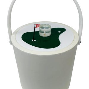 May include: White ice bucket with a matching handle. The lid features a green golf course design with a red flag. A clear, cylindrical object sits atop the lid. The bucket is cylindrical and has a white exterior.