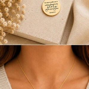 May include: A gold-toned necklace featuring a circular pendant engraved with the text: Yet what we suffer now is nothing compared to the glory he will reveal to us later Romans 8:18. The pendant hangs from a delicate gold-toned chain.