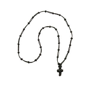 May include: A black rosary necklace with a cross pendant. The necklace is made of knotted black cord, with evenly spaced knots along the length. The cross pendant is also black and has a detailed, textured design.