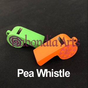 May include: Two pea whistles, one green and one orange, with decorative designs. The green whistle has a purple swirl design and the orange whistle has a pink floral design. Pea Whistle.