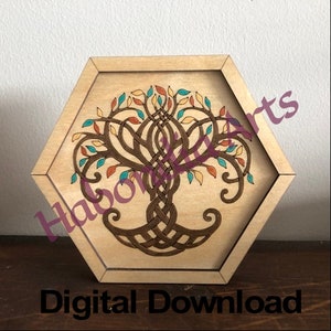 May include: A hexagonal wooden frame with a laser-cut design of a tree with intricate branches and leaves in shades of brown, orange, yellow, blue, and green. The tree is surrounded by a Celtic knot design.
